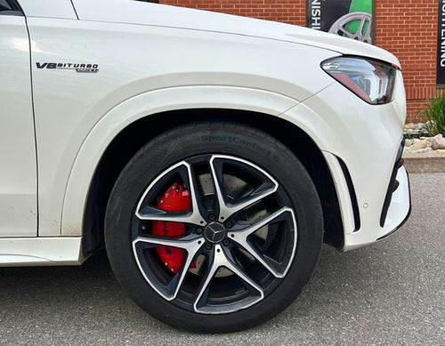 A closeup on a red Mercedes custom caliper cover by Leprecon Plus.