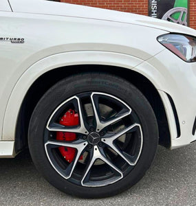 A closeup on a red Mercedes custom caliper cover by Leprecon Plus.